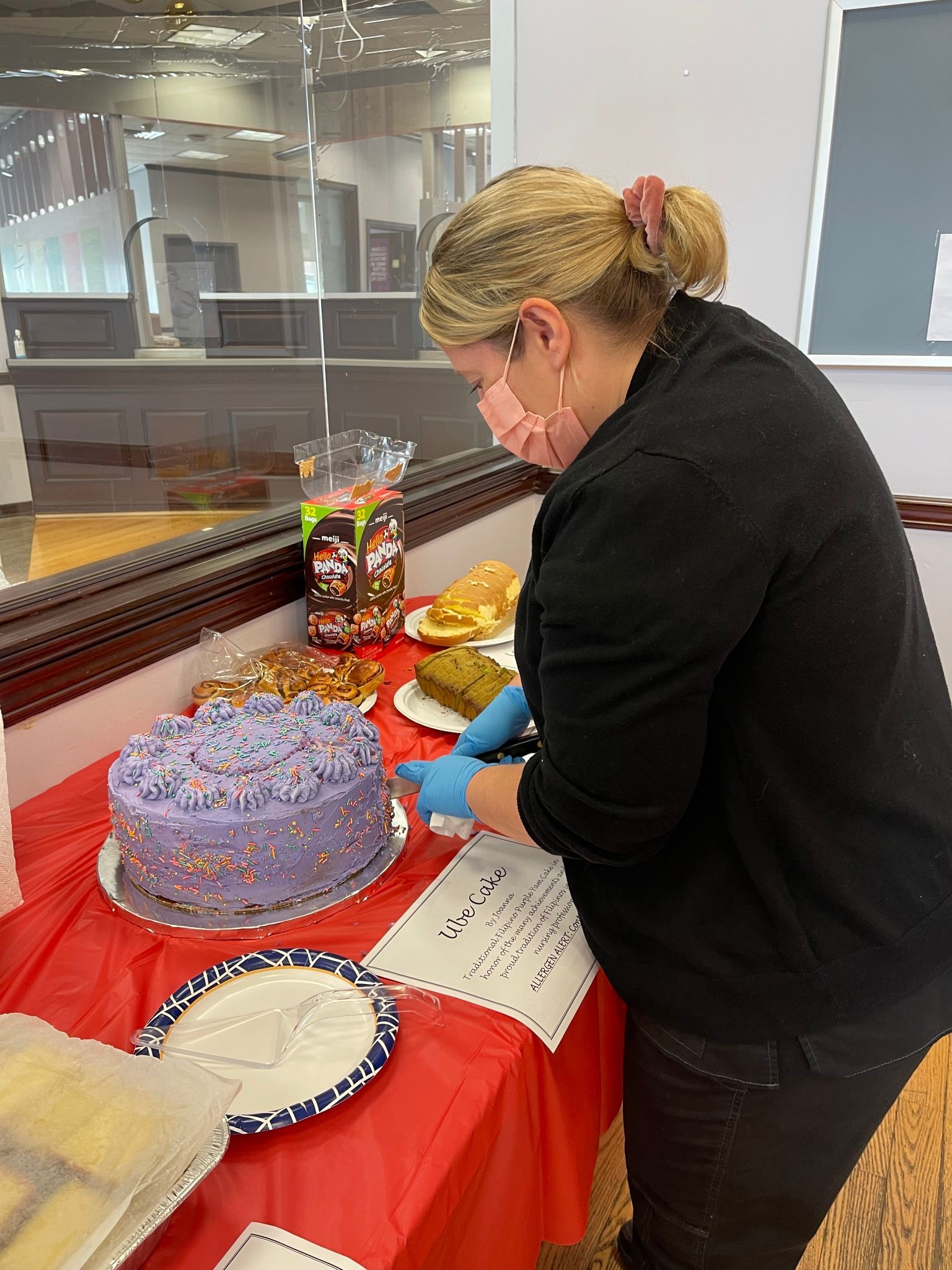 Staff Joanne, RN cutting a cake she baked for nurse appreciation.