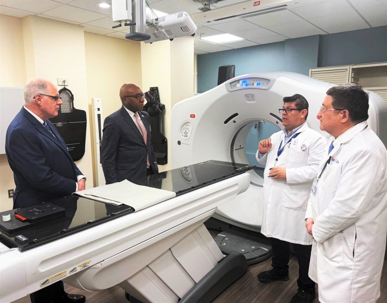 Tomas Saravia, lead therapist (2nd from right), discusses how the new TrueBeam linear accelerator will improve patient care with (from left to right) City Council Member Jim Gennaro and Queens Borough President Donovan Richards — who provided $5 million in funding — as the hospital’s Chief of Radiation Therapy, Dr. William Lee, looks on (far right).